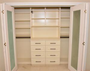 Light almond-coloured reach-in closet reno by Tailored Living as seen on Property Brothers